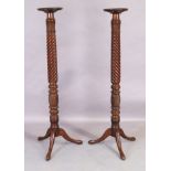 A pair of Victorian mahogany torchere stands, last quarter 19th century, with carved rope twist, ...