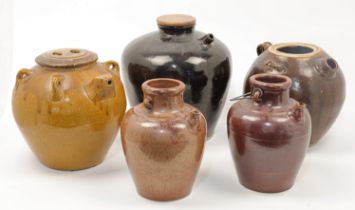 Five large Chinese black, brown and amber glazed stoneware ewers, 20th century one with matching ...