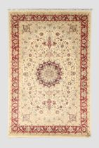 An Indian Kashmir carpet, the central floral medallion surrounded by floral motifs and swags, con...