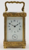 A French gilt-brass and glass panelled carriage clock, 20th century, the serpentine front and bac...