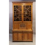 A Victorian light oak secretaire bookcase, last quarter 19th century, the carved cornice with pla...