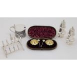 A small group of silver, comprising: a cased set of two Victorian salts and two condiment spoons,...