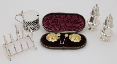 A small group of silver, comprising: a cased set of two Victorian salts and two condiment spoons,...