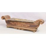 A Chinese carved hardwood Gambang Kayu in the form of a boat, 19th century, parcel gilt and lacqu...