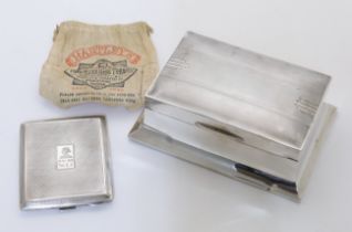 A silver cigarette box, Sheffield, 1934, Walker & Hall, of rectangular form, on a spreading base,...