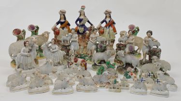 A collection of Staffordshire ceramic figures of predominantly sheep and shepherds, 19th century,...