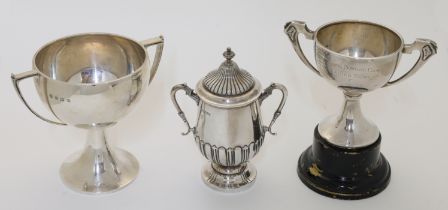 A group of silver cups, comprising: an Edwardian twin handled cup and cover, Sheffield, 1904, Jam...