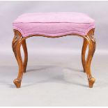 A Victorian walnut stool, in the French taste, third quarter 19th century, on carved cabriole leg...