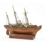 A scratch built model of a ship, 20th century, with three bone masts and wood stand, approx. 18.5...
