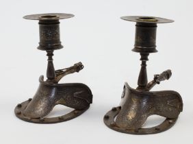 A pair of Spanish damascened horse shoe candlesticks, 19th century, each with wide sconce and bal...