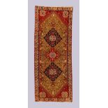 A Persian Qashqai long rug, last quarter 20th century, the central field with three medallions su...