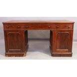 A Victorian mahogany pedestal desk, last quarter 19th century, the tooled leather writing surface...