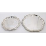 A silver waiter, Sheffield, 1929, Mappin & Webb, of circular form, with shaped border, on three p...