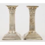 A pair of Victorian short Corinthian column silver candlesticks, London, 1899, William Hutton & S...