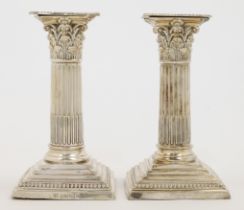 A pair of Victorian short Corinthian column silver candlesticks, London, 1899, William Hutton & S...