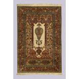 A Persian part silk Qum rug, last quarter 20th century, the central field with large central plan...