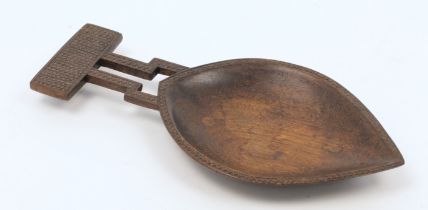 A Fijian carved and patinated hardwood ritual kava oil dish, 20th century, the bowl of leaf shape...