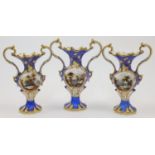 A garniture of three Coalport porcelain twin handled vases, c.1840, each of blue ground with cent...