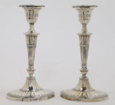 A pair of Victorian silver candlesticks, Sheffield, one 1899 and the other 1900, William Hutton &...