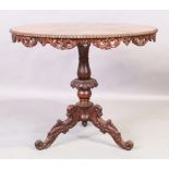 An Italian walnut centre table, first quarter 20th century, the inlaid circular top with carved f...