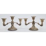 A pair of three light candelabra, stamped STERLING, raised on shaped pedestals, engraved with ini...