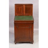 An English mahogany davenport, campaign style, first quarter 20th century, the detachable cupboar...