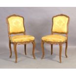 A pair of French beechwood side chairs, Louis XV style, 20th century, with yellow silk damask uph...