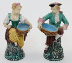 A pair of Minton majolica figures, 1867, impressed MINTON with date code to footrim, modelled as ...