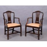 A pair of George III mahogany armchairs, last quarter 18th century, each with arched moulded back...