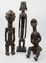 Three African carved wood figures, comprising: a Lagalagana female figure, Mumuye, Nigeria, with ...