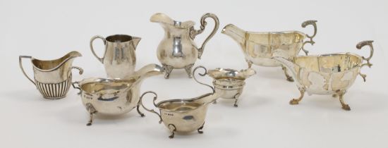 A group of sauce boats and cream jugs, comprising: an Edwardian silver sauce boat, Birmingham, 19...