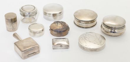 A group of nine pill boxes, comprising: a silver box, London, 1988, Ari D Norman, of circular for...