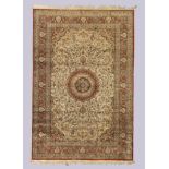 A modern Turkish part silk carpet, the central field with floral medallion surrounded by floral m...