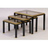 A nest of three tables, c.1970, the black lacquered metal frames inset with clear and mirrored gl...