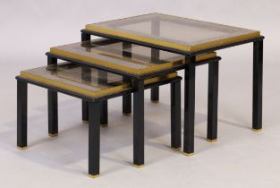 A nest of three tables, c.1970, the black lacquered metal frames inset with clear and mirrored gl...