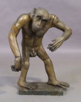 A modern brass cast sculpture of a standing chimpanzee, on loose marble base, the sculpture appro...