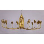 An Italian brass chandelier, c.1950s, with eighteen slender arms issuing from a central cylindric...