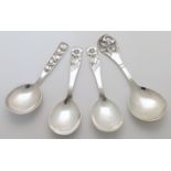 A small group of Danish white metal serving spoons, 20th century, each pierced and decorated with...