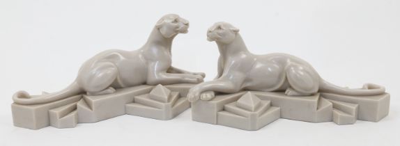 After P. Trudeau, a pair of faux marble reclining panthers, 20th century, each inscribed P. Trude...