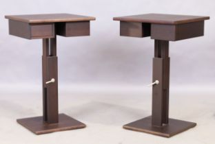 A pair of contemporary side tables, in stained wood, the adjustable height square tops above draw...