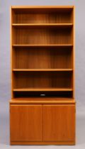 A teak bookcase cabinet, c.1960/70, with four shelves above two cupboard doors, 193cm high, 90cm ...