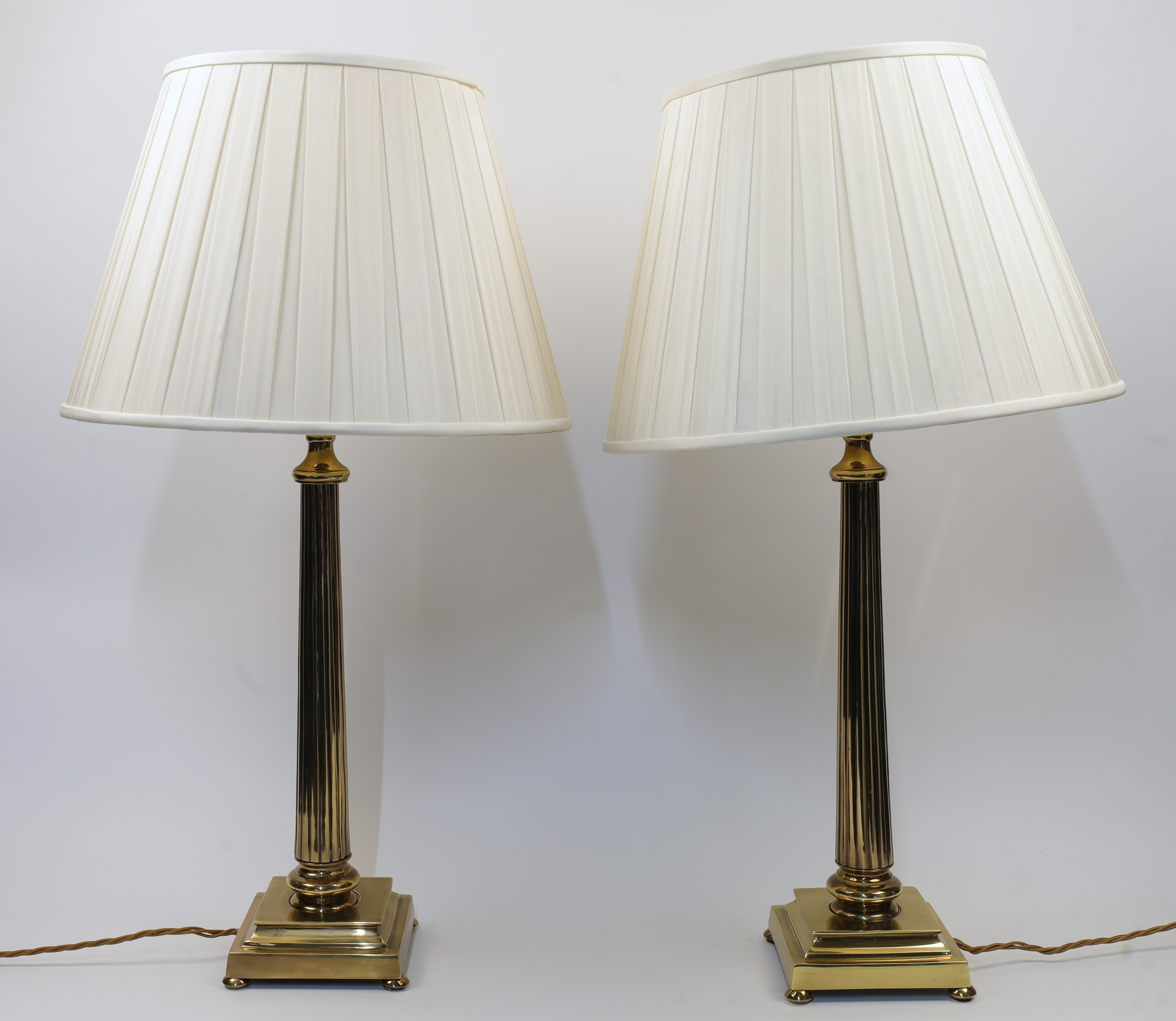 A pair of brass table lamps, 20th century, each of fluted columnar form with stepped base raised ...