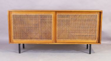 A teak sideboard, mid 20th century, with two caned sliding doors enclosing four drawers and shelf...
