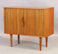 A Danish teak tambour fronted side cabinet, c.1950, the tambour doors enclosing storage space and...