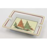 An Hermès porcelain ashtray, 20th century, decorated to the centre with a sailing yacht with gree...