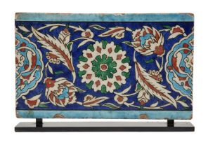 A Rectangular Damascus Iznik Border Tile, Ottoman Syria, 16th century, the central stylized flora...