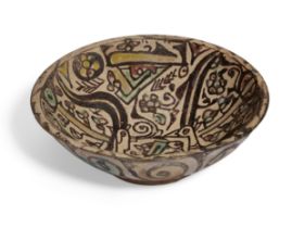 A Nishapur pottery bowl, Northeastern Iran 10th century, of rounded form rising form a short coni...