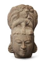 A sandstone head of a deity, Central India, 10th-11th century, or of a bodhisattva, the gaze cast...