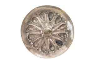 An Achaemenid shallow silver dish, circa 5th Century B.C., decorated with a series of embossed lo...