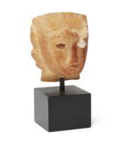 A South Arabian alabaster head, circa 3rd-1st Century B.C., with eyes in sunk relief, one with th...
